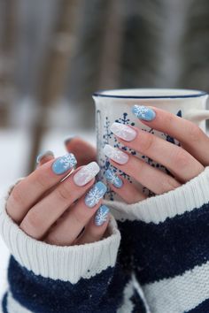 Get ready for the winter season with these stunning blue and white snowflake nail designs. Perfect for anyone looking to add a touch of winter magic to their manicure! These nails are ideal for cozy days spent sipping hot cocoa or attending festive holiday events. Save this pin for your next winter nail art idea. Powder Blue Winter Nails, Nails Snowflakes Winter, Winter Frost Nails, Winter Nails White And Blue, White And Blue Winter Nails, Hot Cocoa Nails, Snow Manicure, Winter Nail Art Snowflakes, Winter Nails Blue And White