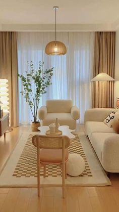 a living room filled with furniture and a chandelier hanging over the top of it