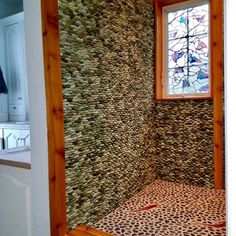 a bathroom that has a window in the wall and a leopard print rug on the floor