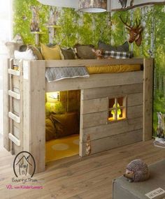 a bunk bed with deer head and trees on the wall in a child's bedroom