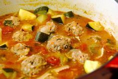 meatball soup with zucchini and tomatoes in a pot