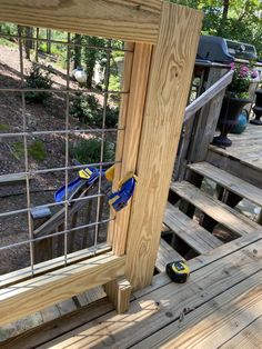 a pair of pliers is stuck into the side of a wooden porch railing with metal bars