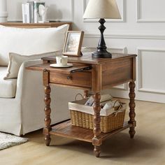 a living room with a couch, coffee table and lamp