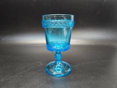 a blue glass sitting on top of a table