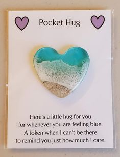 a card with a heart shaped brooch on it's back saying pocket hug, here's a little bug for you for whenever you are feeling blue and a token when i can't be there to remind you just how much