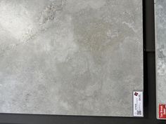 two pieces of gray marble sitting next to each other on a table with a price tag