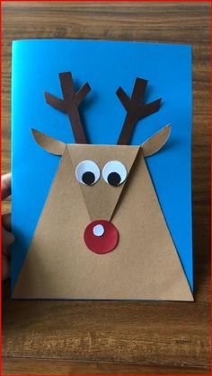 someone is making a paper reindeer card