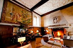 a living room filled with furniture and a christmas tree in the middle of the room