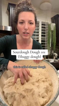 a woman holding a bowl filled with dough in her hands and pointing at the camera