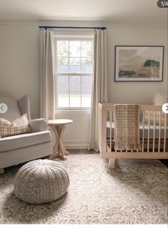 a baby's room with a crib, chair and ottoman