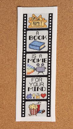 a cross stitch bookmark with words on it