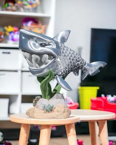 a fish statue on top of a wooden table