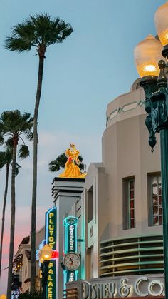 the lights are on and there is a clock in front of it that says disney's hollywood studios