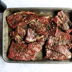 raw meat in a pan next to a cup of milk