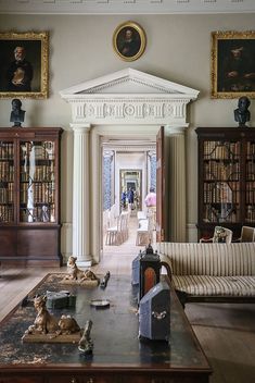 a living room filled with furniture and bookshelves