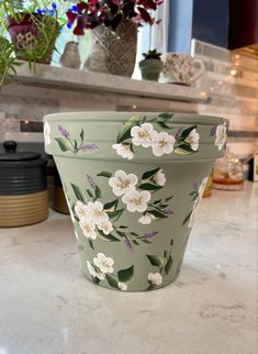 a green flower pot sitting on top of a counter