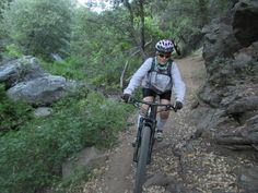 a person riding a bike on a trail