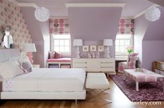 a bedroom with purple walls and white furniture