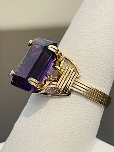 The wire-wrapping on this gold-filled ring is superb, an extremely talented artist crafted this. The synthetic purple stone is gorgeous; grape purple and 14 x 10 mm. This ring is a size 8 1/2. Lemon Quartz Ring, Cinderella Slipper, Dragon Ring, Glendale Az, Gold Filled Ring, Purple Band, Wire Wrapped Rings, Cubic Zirconia Rings, Tourmaline Ring