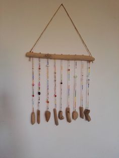 a wall hanging made out of wood and beads