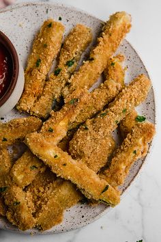 fried fish sticks on a plate with dipping sauce