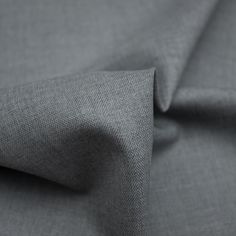 a close up view of the fabric on a grey shirting material that is very soft