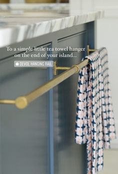 a towel hanging on a rail in a kitchen