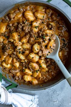 a skillet filled with pasta and meat