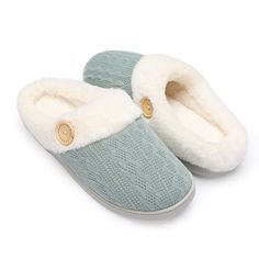 a pair of blue slippers with white fur on the bottom and two gold buttons