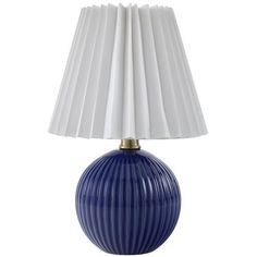 a blue and white lamp with pleated shades on the shade is sitting in front of a white background