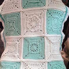 a crocheted blanket sitting on top of a chair