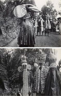 an old black and white photo of some people in native garb standing near trees