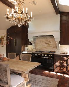 a chandelier hanging from the ceiling in a kitchen