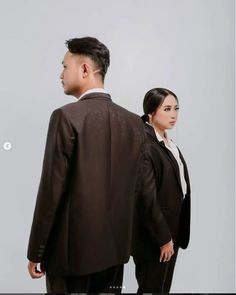 a man and woman in business attire looking at each other's side by side