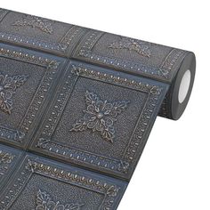 a roll of metallic foil with decorative designs on it's sides and an intricately designed design