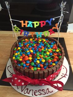 a birthday cake decorated with chocolate and colorful candies