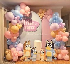 an image of a birthday party setting with balloons and cartoon characters on the stage set up