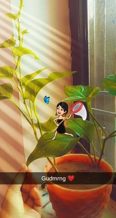 a person holding a plant with a tennis racket in it's hand while another person holds a blue butterfly