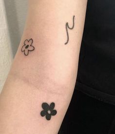 a woman with a tattoo on her arm has a music note and four leaf clover