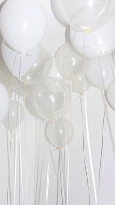 white balloons are floating in the air