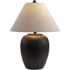 a black lamp with a white shade on it