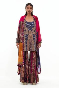 Multicolor kurta with antique dori, mirror embroidery in afghan artwork pattern. Paired with sharara and dupatta.
Components: 3
Pattern: Embroidery
Type Of Work: Dori, mirror
Neckline: Deep round neck
Sleeve Type: Sleeveless
Fabric: Mushroom Twill, Italian Crepe, Sheer Silk
Color: Multi Color
Other Details: 
Note: All the jewellery worn by the model is not for sale
Disclaimer: The product may have slight variation in print
Occasion: Sangeet - Aza Fashions Multicolor Sharara With Cutdana Straight Kurta, Transitional Multicolor Sharara In Chanderi, Transitional Multicolor Chanderi Sharara, Multicolor Chanderi Palazzo Set With Dupatta, Multicolor Silk Palazzo Set With Dupatta, Transitional Multicolor Sharara With Sheer Dupatta, Transitional Multicolor Sharara With Dupatta, Transitional Multicolor Sharara With Mirror Work, Silk Palazzo Set With Mirror Work In Multicolor