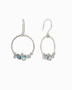 The Stone Cluster Drop Earrings feature a gently hammered sterling silver loop shape adorned with a cluster of ocean-inspired blue and clear stones. This elegant yet whimsical design will complement any jewelry collection. Metal: Sterling silver Stones: London blue topaz, Hampton blue topaz, white zircon Dimensions: 35mm x 12mm Style #: E197LbHbZ Anniversary Blue Topaz Multi-stone Earrings, Anniversary Multi-stone Blue Topaz Earrings, Blue Multi-stone Sterling Silver Earrings, Sterling Silver Gemstone Cluster Earrings, Sterling Silver Earrings With Gemstone Accents, Sterling Silver Round Earrings With Gemstone Accents, Sterling Silver Gemstone Cluster Earrings Fine Jewelry, Sterling Silver White Gold Earrings With Gemstone Accents, Modern Sterling Silver Earrings With Gemstone Accents