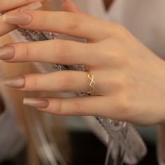 a woman's hand with a ring on it