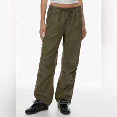 Aritzia Cargo Pants Nwt Size Small Originally $128 Relaxed Mid-Rise Parachute Pants Smooth Landings Only These Are Mid-Rise Parachute Pants With A Relaxed Fit And Adjustable Drawcords At The Waist And Hem. They’re Made With Softsupply Smooth-Faced 100% Cotton Fabric That Wears In Well For A Soft, Washed-Down Feel. They’ve Been Recently Updated For An Even Better Fit. Slash Hand Pockets Back Pockets With Flaps Zip Fly With Button Closure Articulated Knee For Better Mobility Exclusive Tna Embroide Aritzia Tna Jumpsuit, Aritzia Cargo, Cargo Pants Color, Aritzia Tna, Smooth Face, Aritzia Pants, Embroidery Materials, Green And Brown, Track Pants