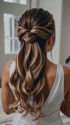 a woman with long hair wearing a white dress