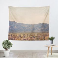 a desert scene with cactus trees and mountains in the background tapestry wall hanging art print