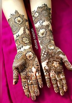 two hands with henna tattoos on them