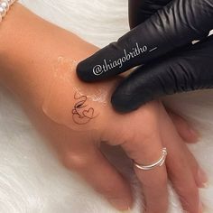 a woman's hand with a tattoo on her left wrist and the word love written in cursive writing