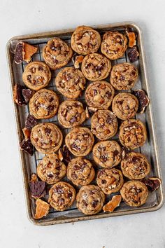 chocolate chip cookies on a baking sheet with dried fruit and nuts in the middle, ready to be eaten